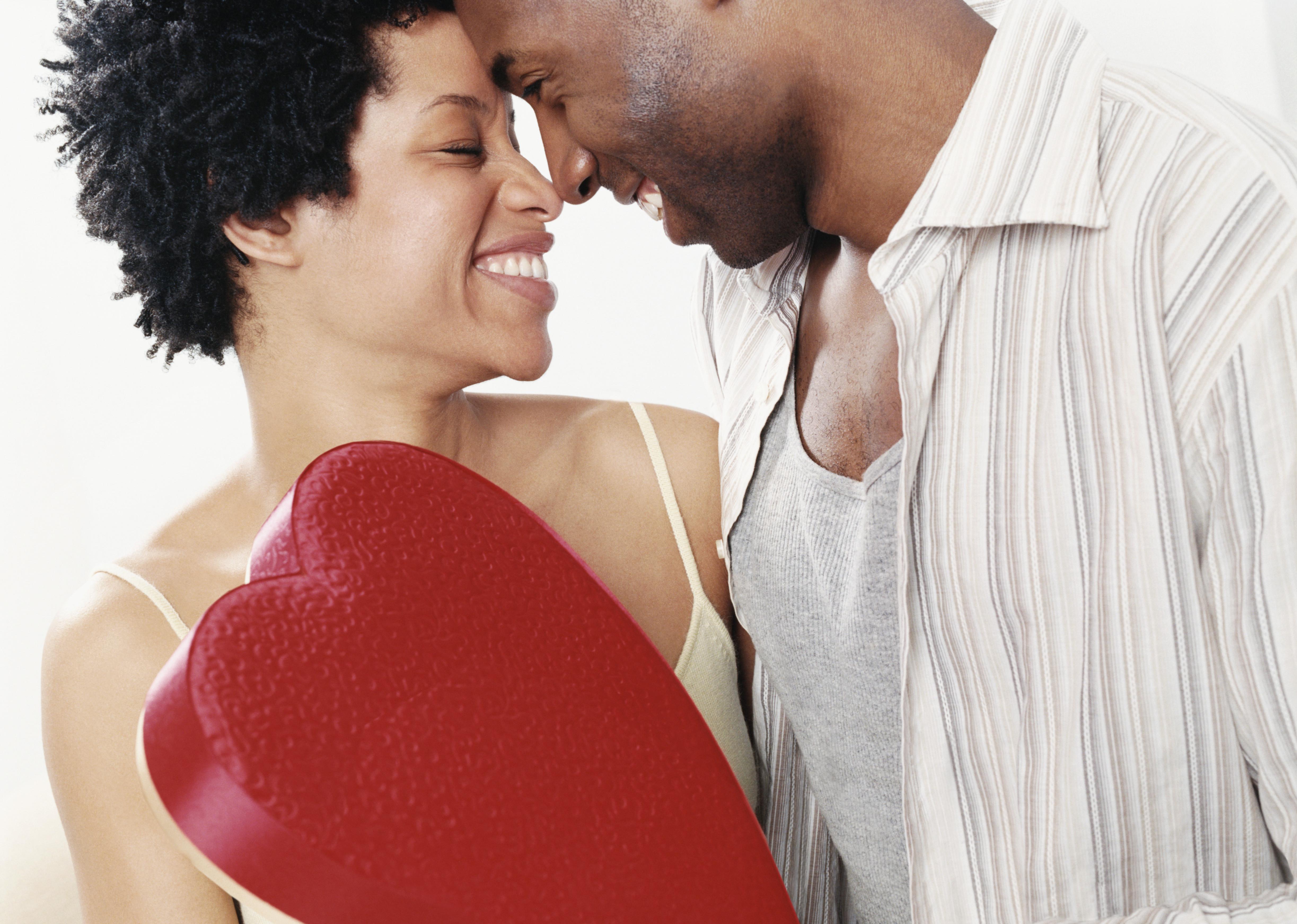 Couple Face to Face, Man Holding a Red Heart Shaped Box of Chocolates