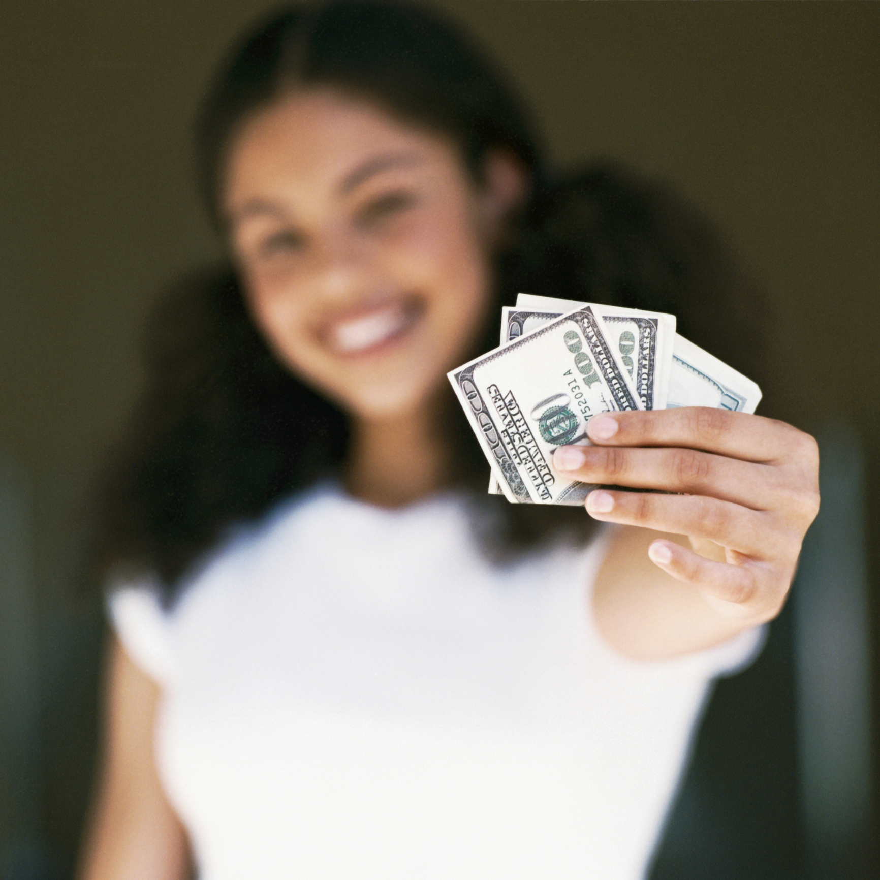 Woman holding US currency